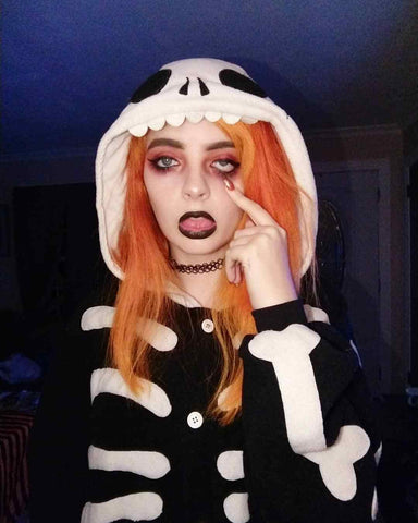 Girl wearing a Skeleton Kigurumi on Halloween, making a face