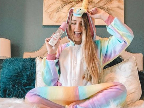 a girl enjoys the raimbow unicorn kigurumi she got for her birthday